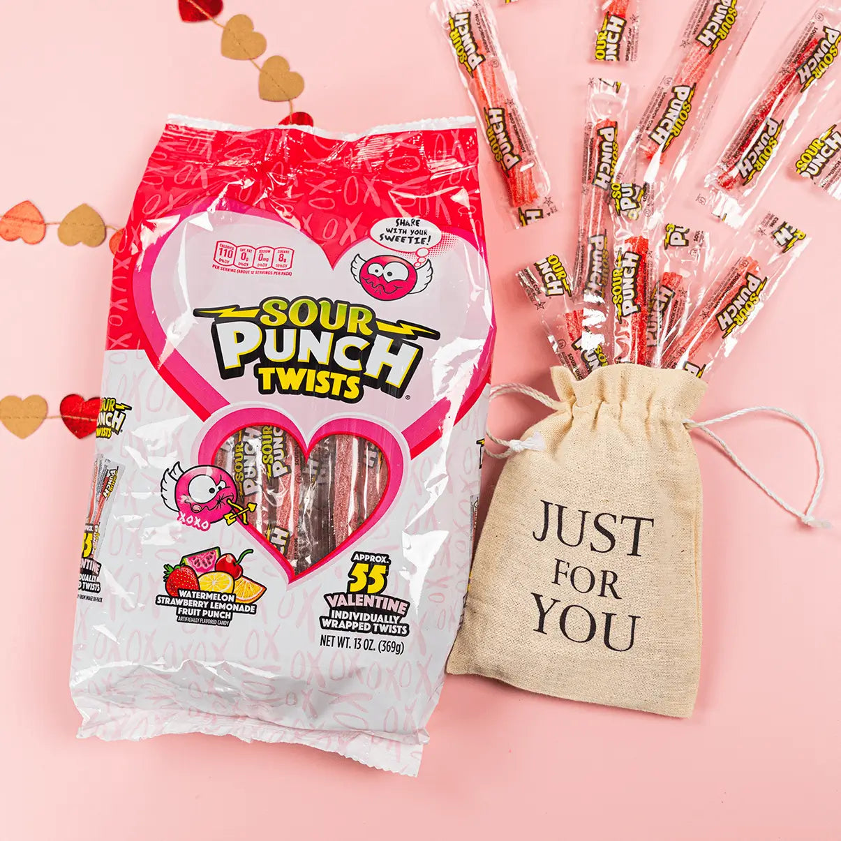 Sour Punch Valentine's Day Individually Wrapped Twists 13oz Bag in a valentine's day scene with pink background