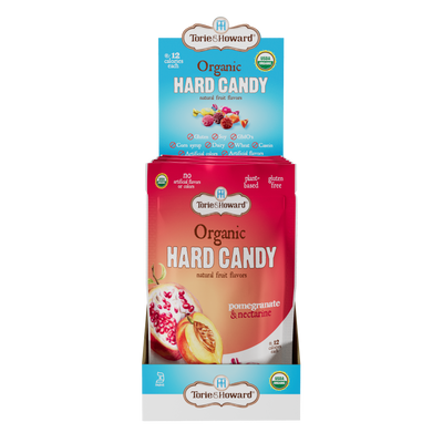 Display caddy containing 6, 3.5oz bags of Torie & Howard Pomegranate & Nectarine Organic Hard Candy