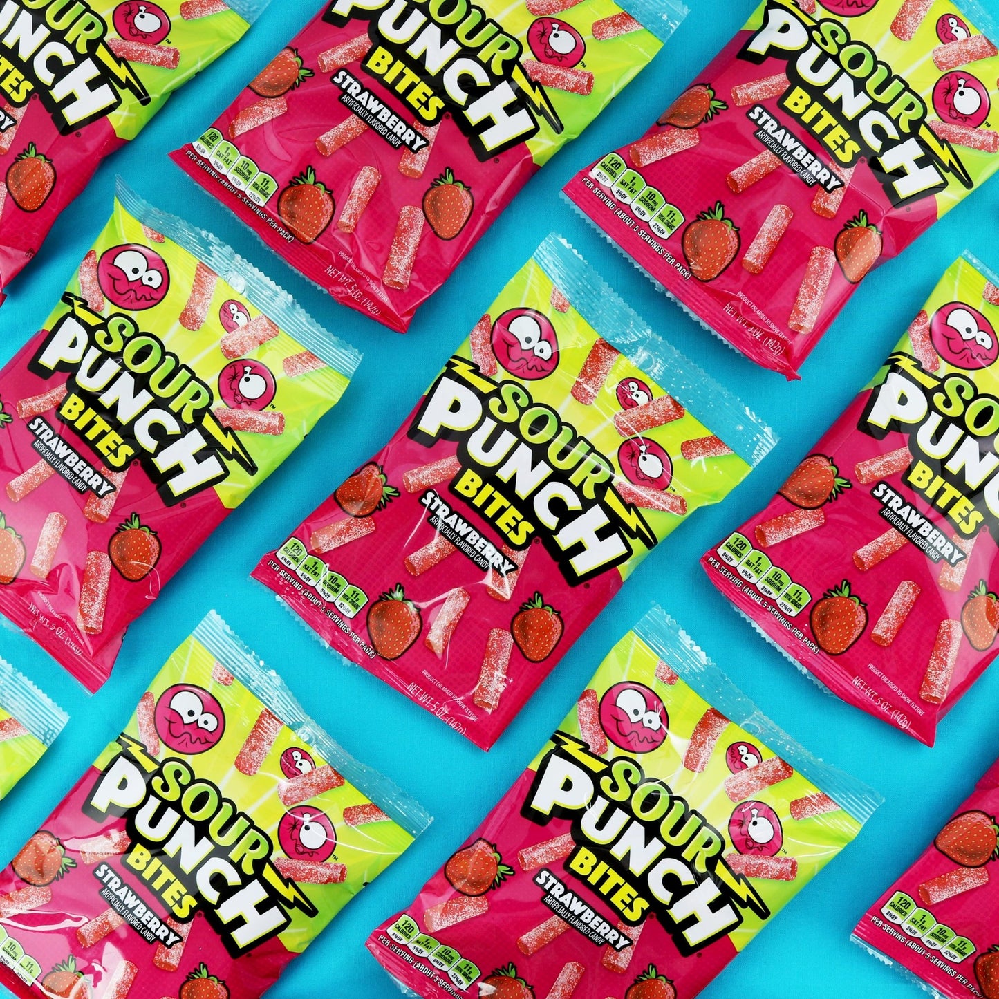 Bulk SOUR PUNCH Strawberry Bites hanging bags spread out on a blue background Bulk SOUR PUNCH Strawberry Bites hanging bags spread out on a blue background