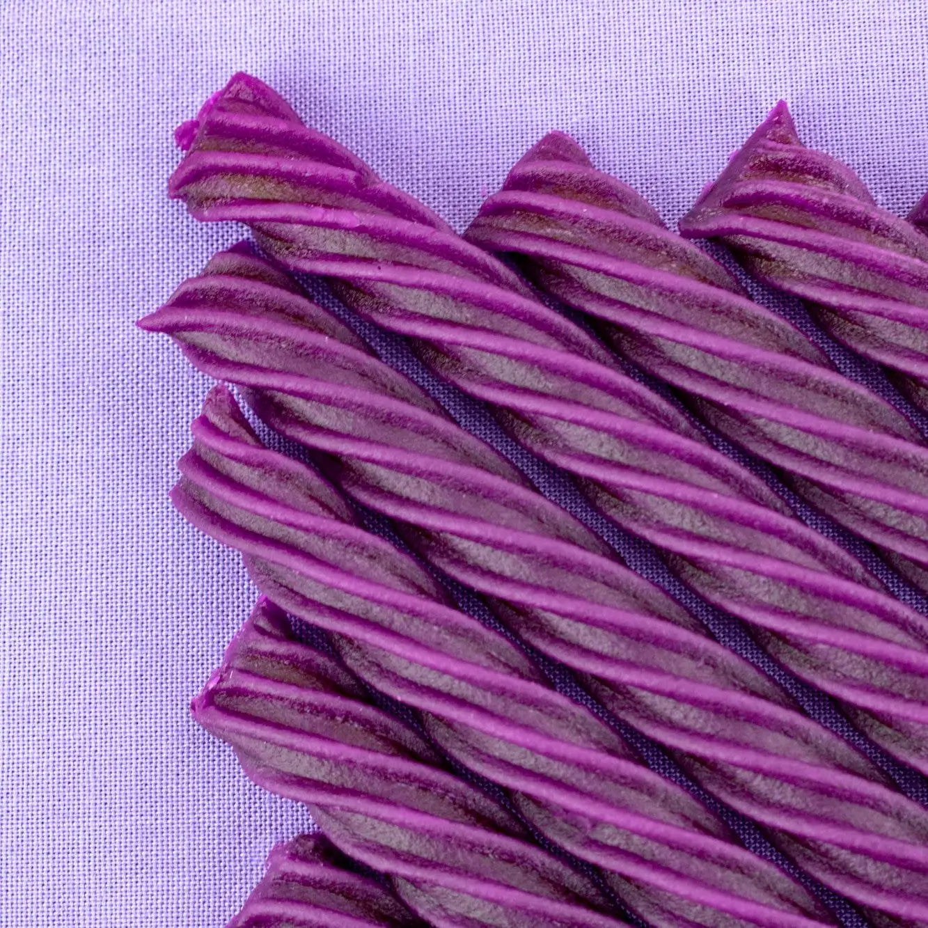 Chewy Grape Purple Licorice Twists with a light purple background