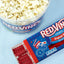 Red Vines Original Red Licorice 4oz Movie Tray on a light blue background beside popcorn