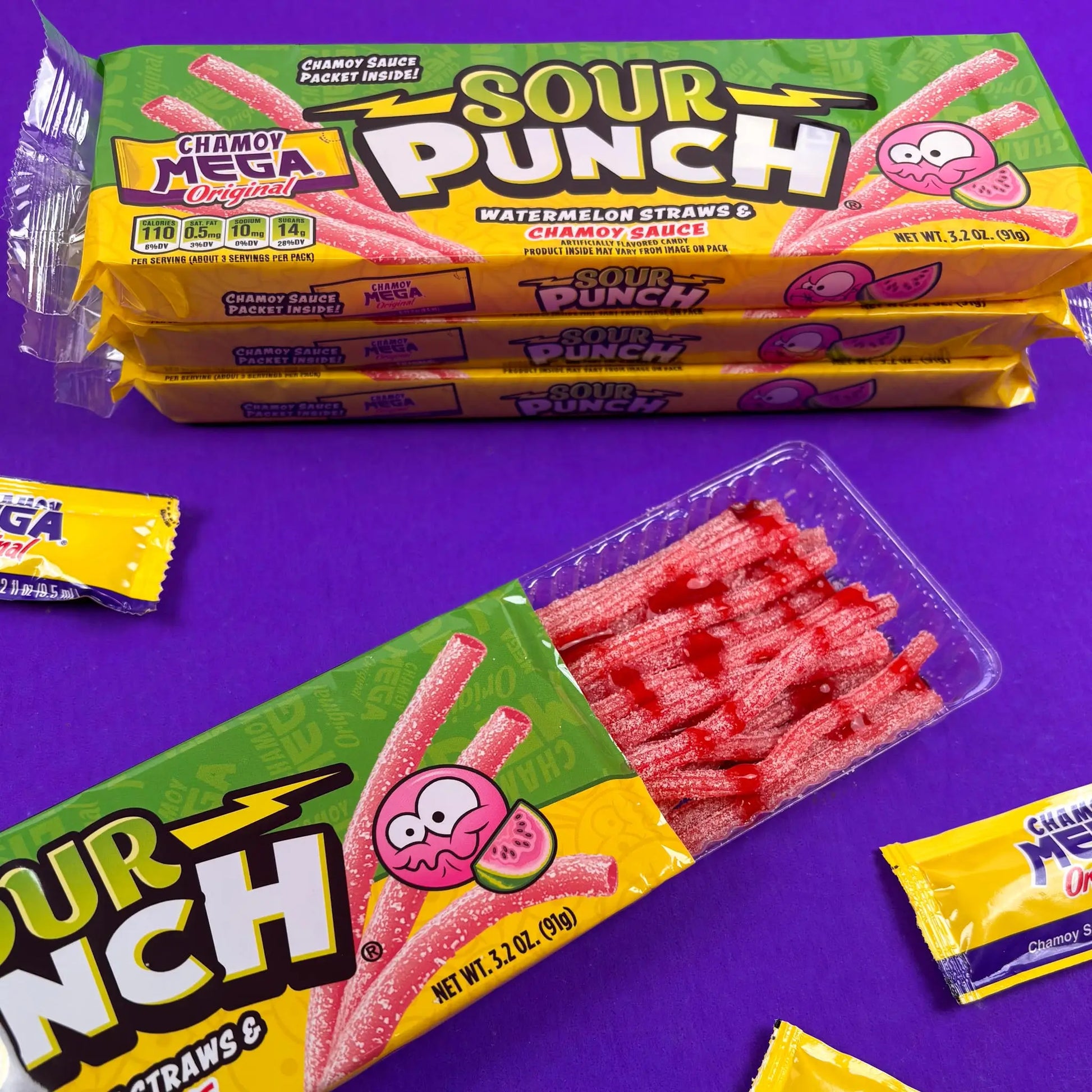 Sour Punch Watermelon Straws with Mega Chamoy Sauce drizzled on them