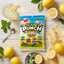 Sour Punch Lemonade Filled Bites 5oz Bag on a table with lemons, candy bites, and fresh lemonade
