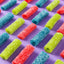 Sugar coated sour candy bites with blue raspberry, strawberry, and green apple flavors
