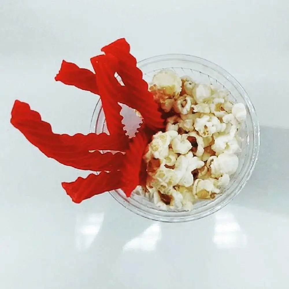 Original Red Chewy Licorice Twists in a cup with popcorn