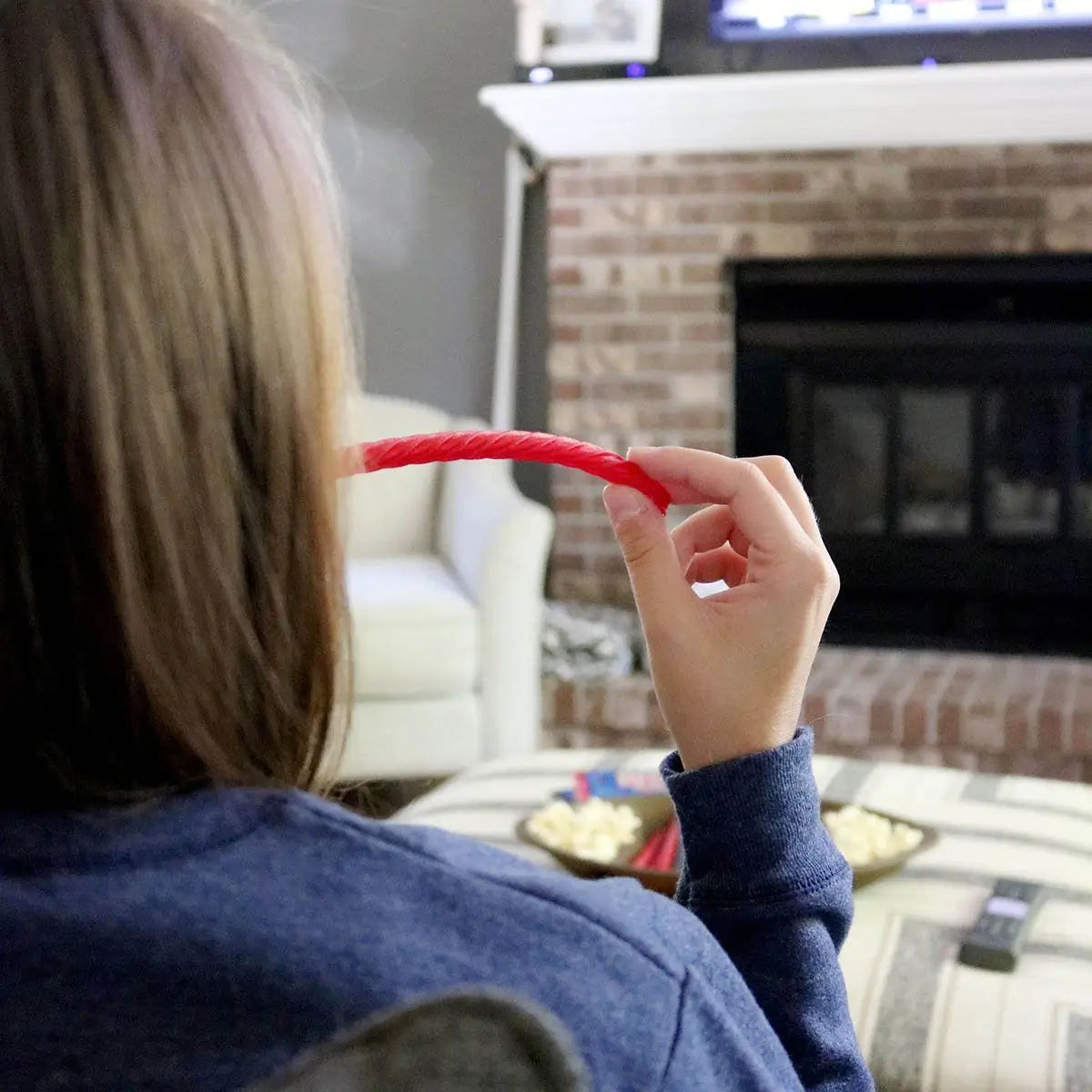 Enjoying Original Red Chewy Licorice Twists with popcorn