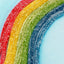 Strawberry, Lemon, Green Apple, and Blue Raspberry sour straws in the shape of a rainbow