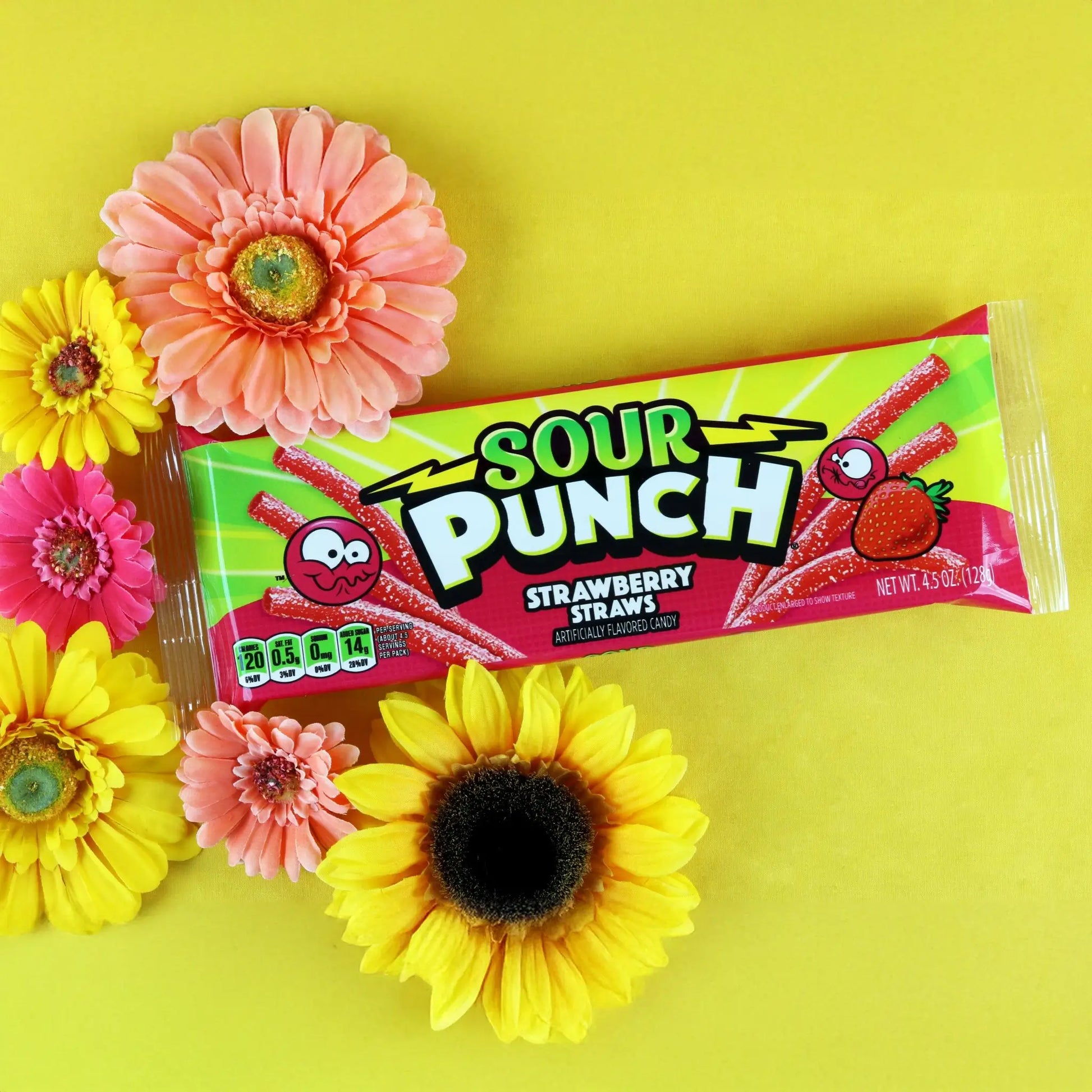 Sour Punch Strawberry Straws 4.5oz Tray with flowers on a yellow background