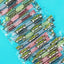 Bulk individually wrapped candy twists in assorted flavors on a light blue background