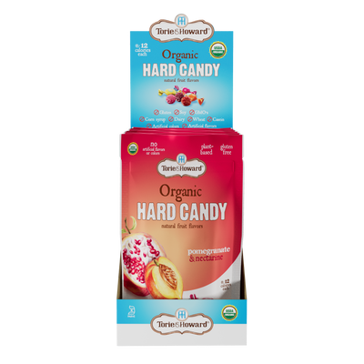 Display caddy containing 6, 3.5oz bags of Torie & Howard Pomegranate & Nectarine Organic Hard Candy 