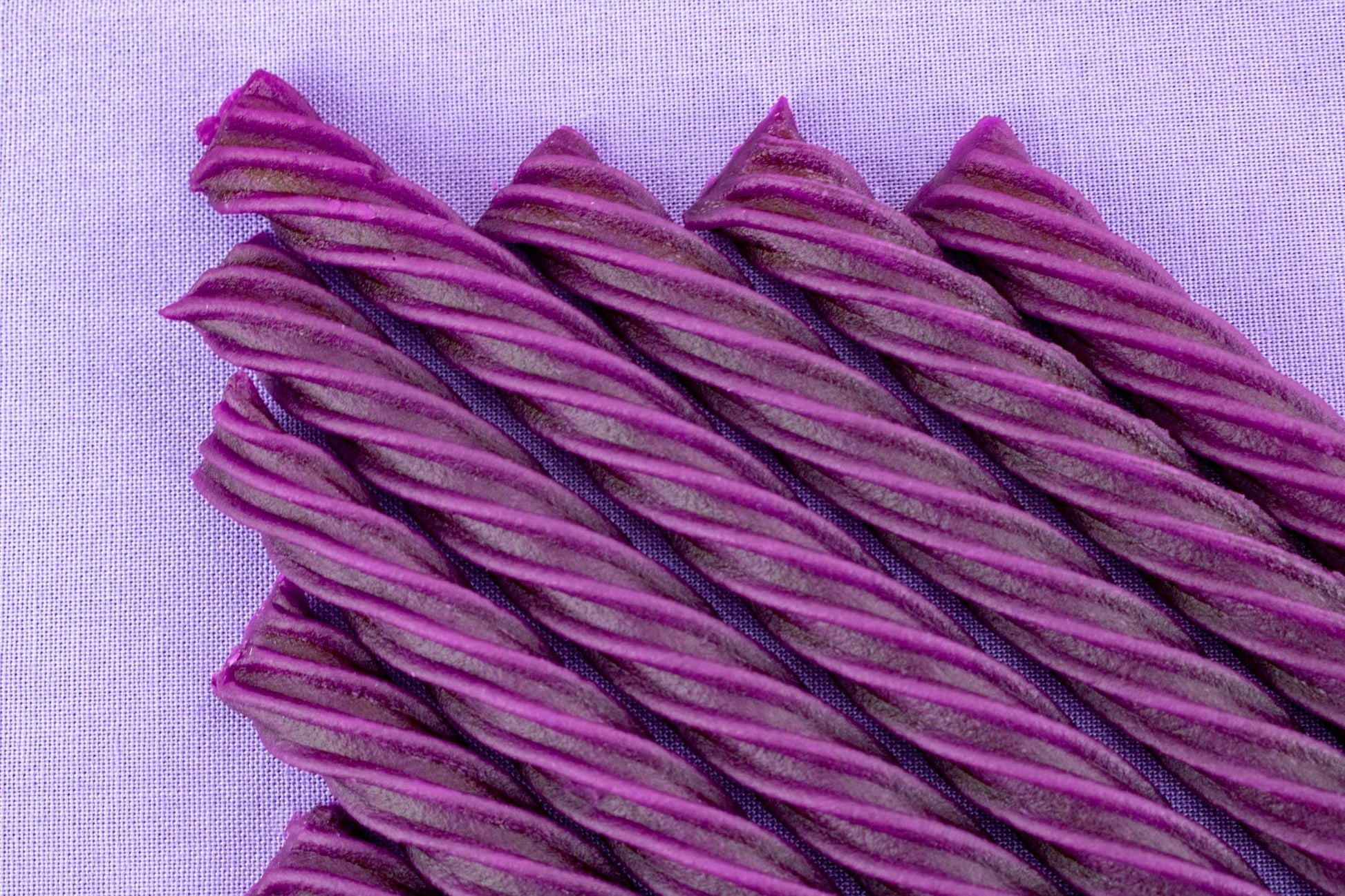 Chewy Grape Purple Licorice Twists with a light purple background